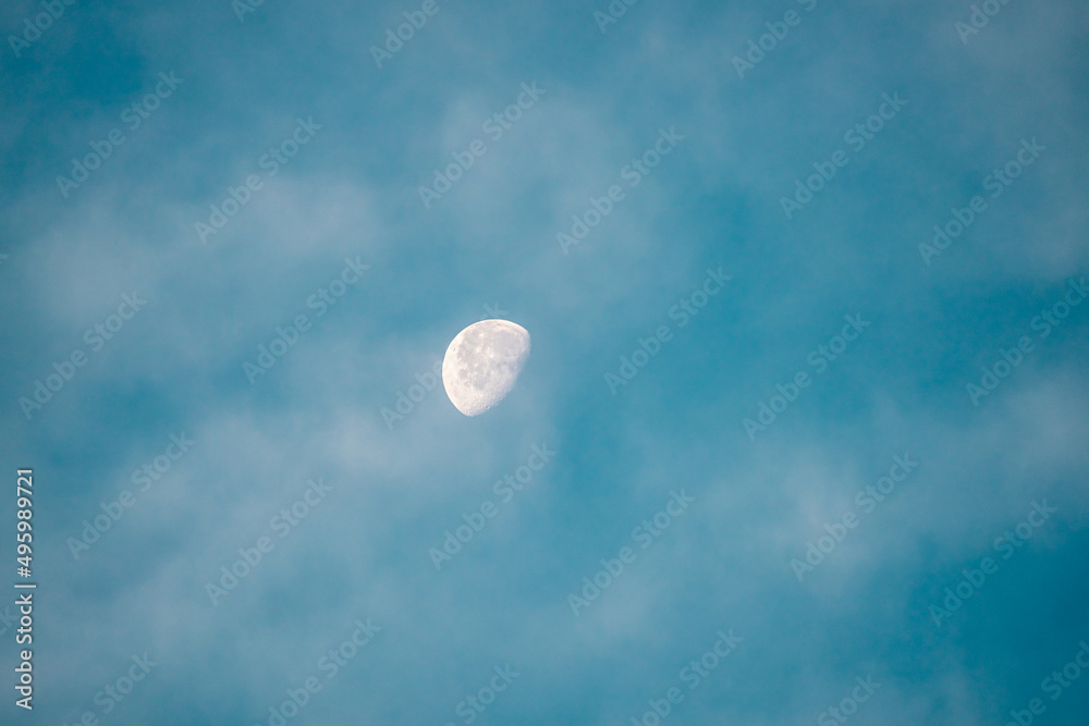 blue sky with white clouds and half moon at morning blue sky with white clouds and half moon at morning