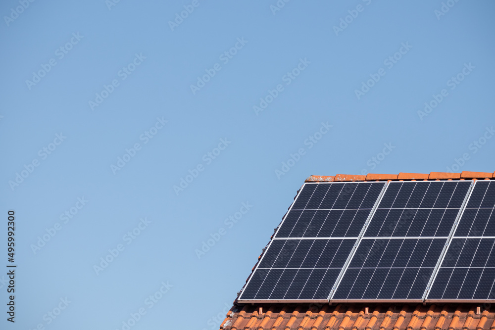 Solar photovoltaic panels on a house roof for renewable energy with blue sky Solar photovoltaic panels on a house roof for renewable energy with blue sky