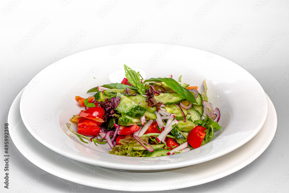 Vegetable salad of tomatoes, cucumbers, lettuce leaves, radishes, with olive oil Vegetable salad of tomatoes, cucumbers, lettuce leaves, radishes, with olive oil