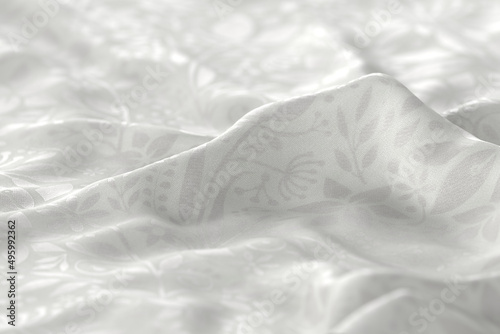 White fabric with a reflective floral pattern