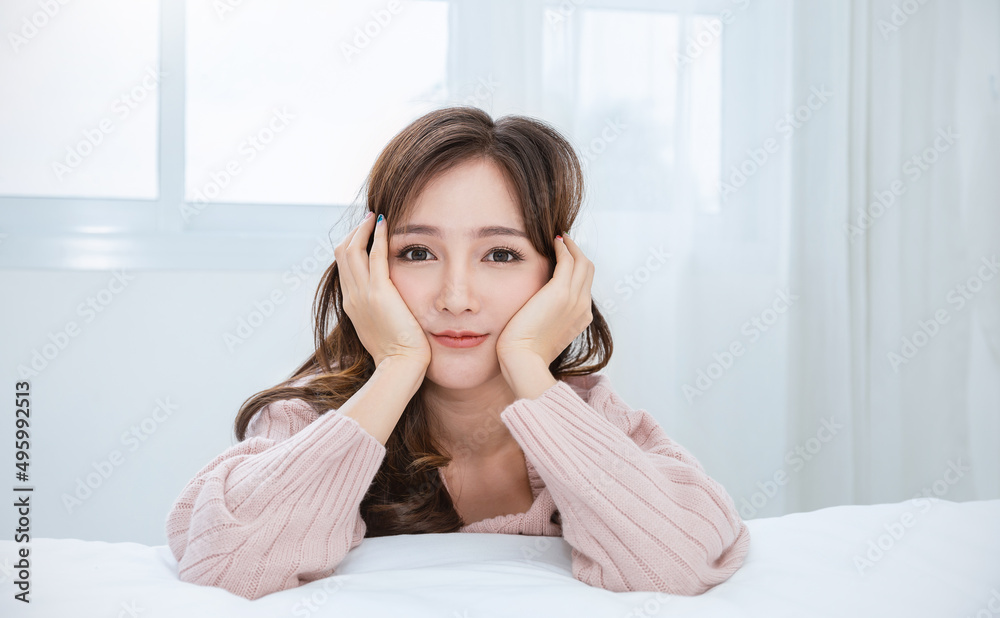 Portrait young beautiful asian woman relax in bedroom. Smile happy asian teenage girl with clear perfect japanese korean makeup skin isolated on white background. Cold winter lifestyle concept. Portrait young beautiful asian woman relax in bedroom. Smile happy asian teenage girl with clear perfect japanese korean makeup skin isolated on white background. Cold winter lifestyle concept.