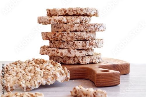 Healthy quick snack: a stack of oatmeal cookies on a wooden kitchen board, close-up, light background