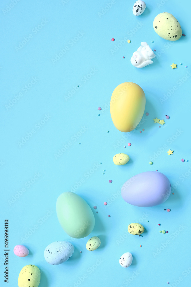 Fototapeta premium Easter composition. Easter eggs and easter bunny on pastel blue background. Minimal concept of Easter. Flat lay, top view, copy space.