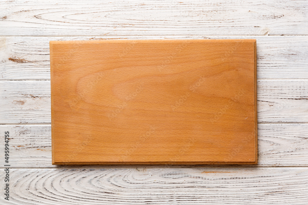 Top view of wooden cutting board on wooden background. Empty space for your design.=