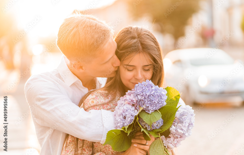 loving couple at sunset with flowers