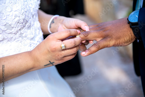 Bride putting ring on grooms`s finger closeup of hands and ring