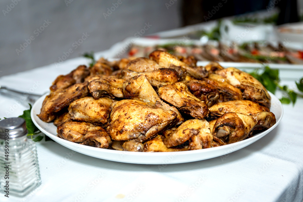 Golden brown baked chicken thighs served on a round white platter
Golden brown baked chicken thighs served on a round white platter
