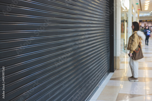Stores show case in shopping mall closed due to sanctions, boycott and embargo, mass market cloth shops work stoppage with closed storefronts, retail business suspension and brands leaving market photo