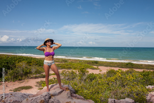 Lady at the beach known as Taipe near the colorful cliffs in Arraial d Ajuda Bahia, Brazil photo