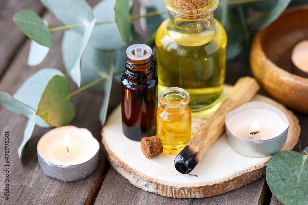 Assortment of natural oils in glass bottles on wooden background. Concept of pure organic ingredients in cosmetology. Bath accessories, atmosphere of harmony, relax. Close up macro. Healthy lifestyle Assortment of natural oils in glass bottles on wooden background. Concept of pure organic ingredients in cosmetology. Bath accessories, atmosphere of harmony, relax. Close up macro. Healthy lifestyle