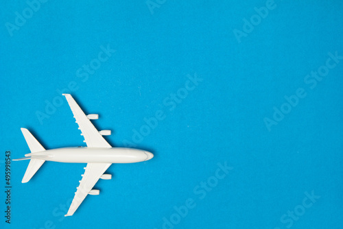 Airplane model. White plane on blue background. Travel vacation concept. Summer background. Flat lay. © hamara