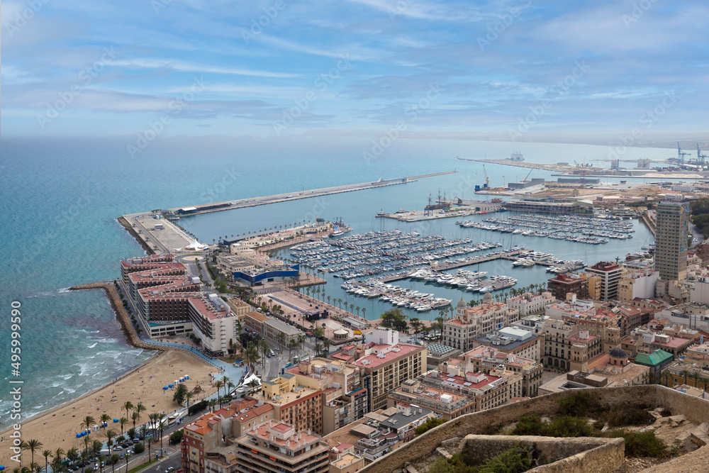 Wide angle view of the modern city of Alicante, Spain. Panoramic view of Postiguet sandy beach, city and harbor with yachts