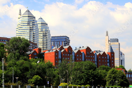 Photos Beautiful tall white towers, skyscrapers, red buildings, against sky in summer and spring