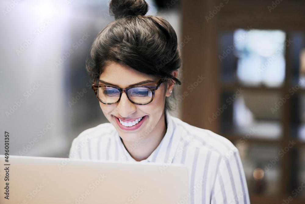 Here to fulfill my ambitious business dreams. Shot of a confident young businesswoman working on a laptop in an office. Here to fulfill my ambitious business dreams. Shot of a confident young businesswoman working on a laptop in an office.