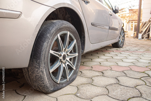 flat tire accident in car park on the street waiting for repair. Flat tire and spare concept