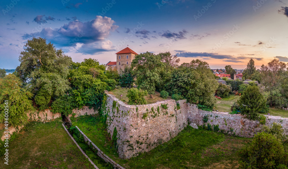 Aerial sunset view over the old lake of Tata with medieval castle surrounded by moat, bastions and walls in Hungary