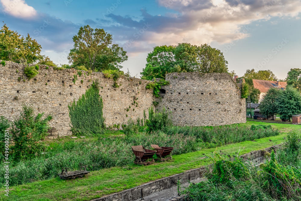 Fototapeta premium Late afternoon view of Tata castle rondel and moat turned into a garden 