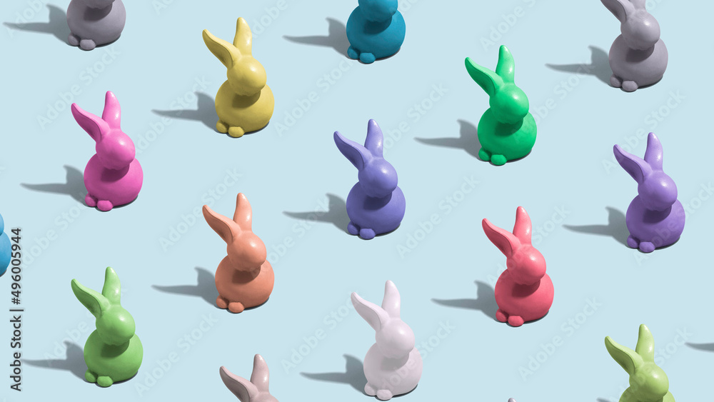 Fototapeta premium Bunnies in multiple colors. Colorful minimal Easter concept. Figures align in pattern.