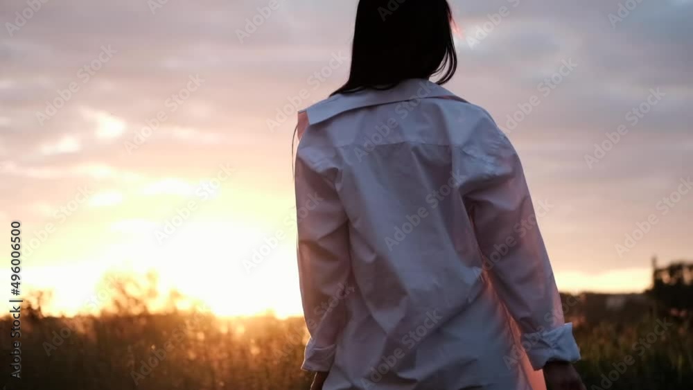 brunette woman in white blouse with baldric on summer field on sunset. peaceful time. millennial generation. calm female. brunette woman in white blouse with baldric on summer field on sunset. peaceful time. millennial generation. calm female.