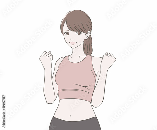 ガッツポーズをするスポーツインストラクターの女性