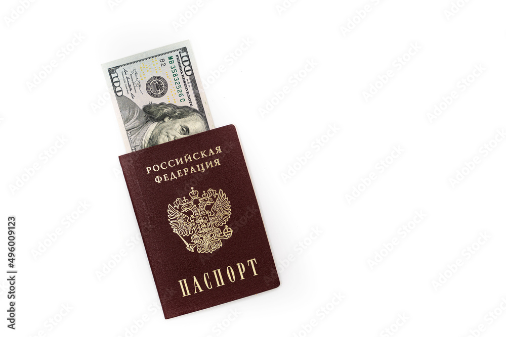 American dollars, 100 dollar bills lie in the passport of the Russian Federation, close-up on a white background American dollars, 100 dollar bills lie in the passport of the Russian Federation, close-up on a white background