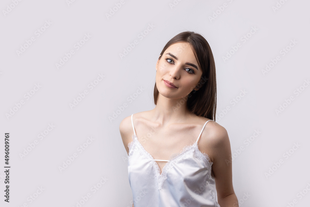 Beautiful smiling woman with clean skin, natural make-up and white teeth on a gray background Beautiful smiling woman with clean skin, natural make-up and white teeth on a gray background