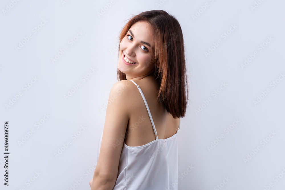 Beautiful smiling woman with clean skin, natural make-up and white teeth on a gray background Beautiful smiling woman with clean skin, natural make-up and white teeth on a gray background
