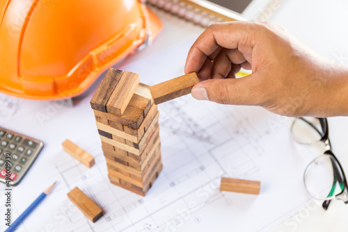 concept construction engineer / wooden block tower on the desk of architect / architectural analysis and planning projects.