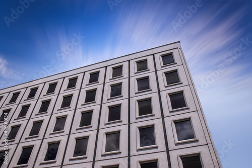 Medium rise office building showing facade of precast concrete exterior panels, windows, daytime, nobody