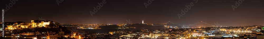Ultra wide skyline panorama of Lisbon at night. Portugal