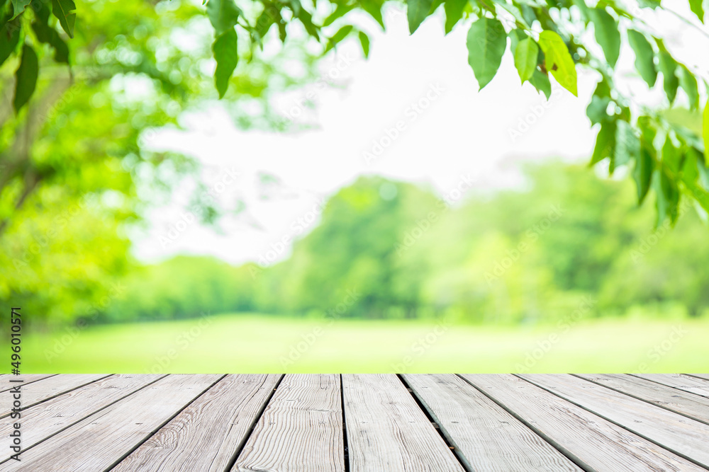 Empty wooden table with garden bokeh for a catering or food background with a country outdoor theme,Template mock up for display of product Empty wooden table with garden bokeh for a catering or food background with a country outdoor theme,Template mock up for display of product