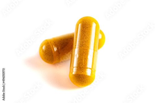 Ground Turmeric in Capsule form on a White Background