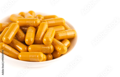 Ground Turmeric in Capsule form on a White Background