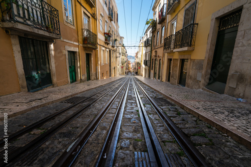 Tram tracks at the narrow street in the Lisbon, a detail metal rails for the tram