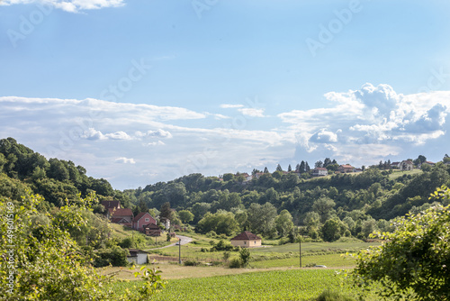typical European countryside landscape, with road with farms, agricultural fields, trees, in a valley near Barajevo, Central Serbia, in Kosmaj mountain, in a traditional European rural environment...