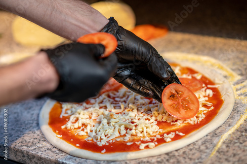 Chef baking pizza in the italian pizzeria