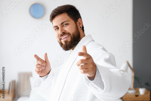 Handsome man in bathrobe da...