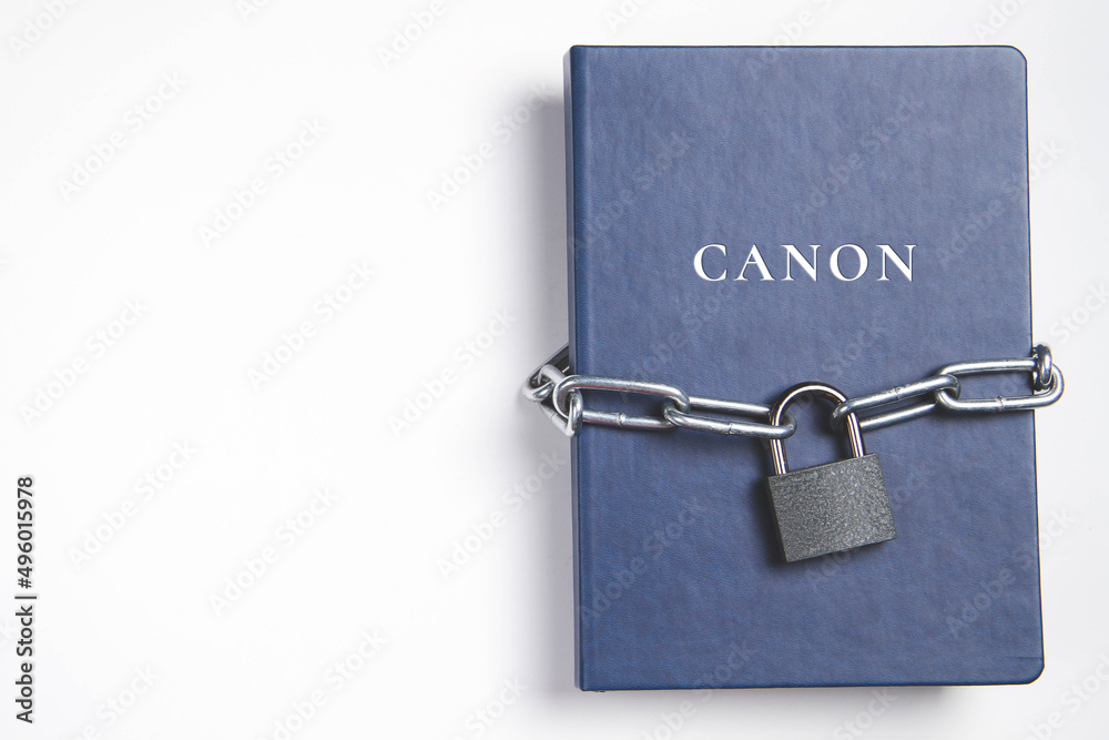 Canons. Book with lock. A closed book is banned. Chain wrapped the book. Canons. Book with lock. A closed book is banned. Chain wrapped the book.