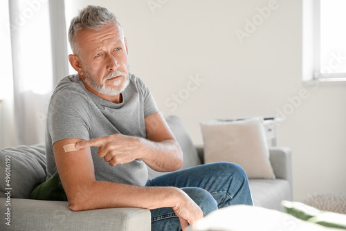 Obraz na plátne Mature man with applied nicotine patch at home. Smoking cessation