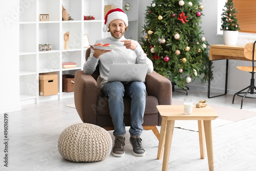 Young man in Santa hat with...