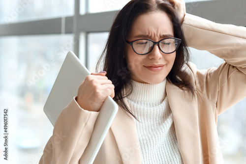 Worried young businesswoman...