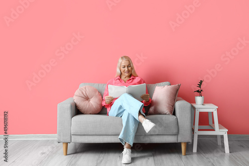 Mature woman reading book w...