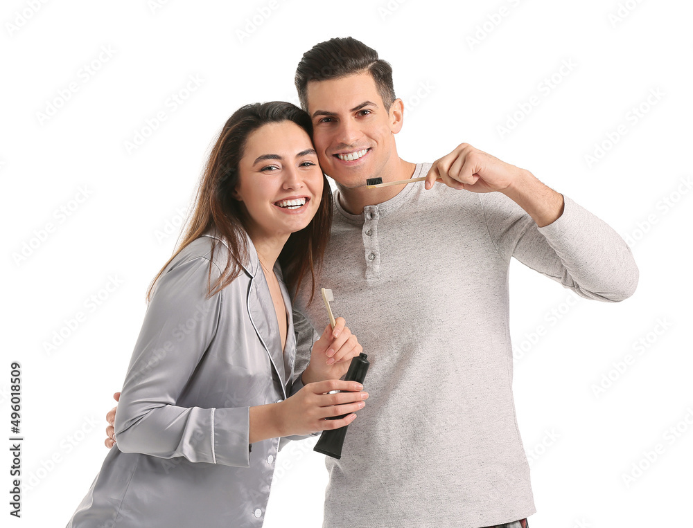Young couple with charcoal tooth paste isolated on white Young couple with charcoal tooth paste isolated on white