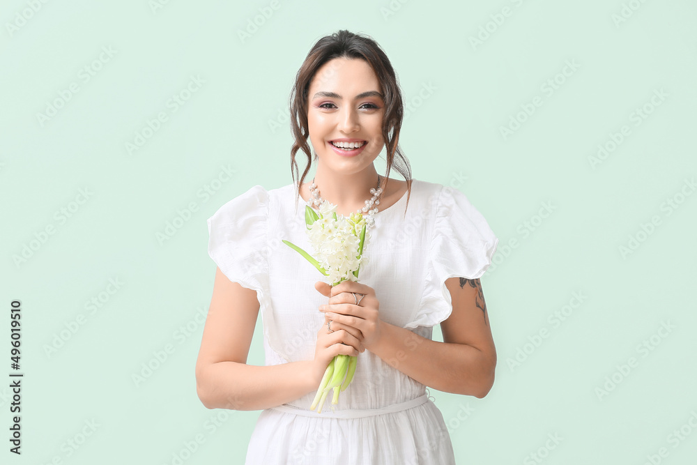 Pretty young woman with hyacinth flowers on green background Pretty young woman with hyacinth flowers on green background