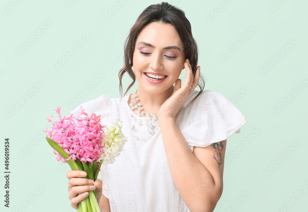 Pretty young woman with hyacinth flowers on green background Pretty young woman with hyacinth flowers on green background