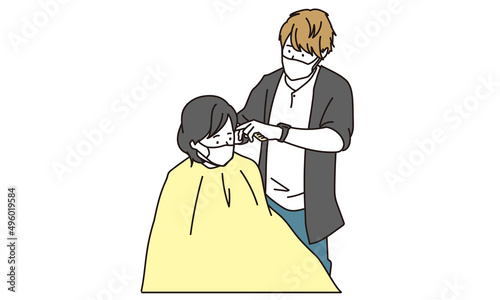 マスクをしてヘアカットをするアジア人の美容師