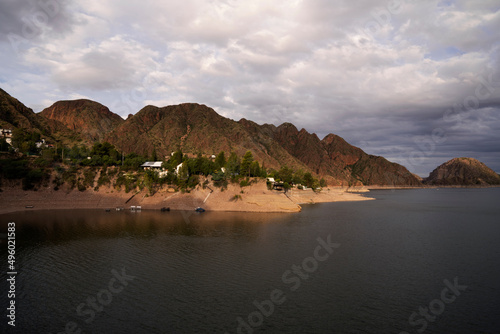 Tourism. View of the lake and rocky mountains under a beautiful cloudy sky.  photo