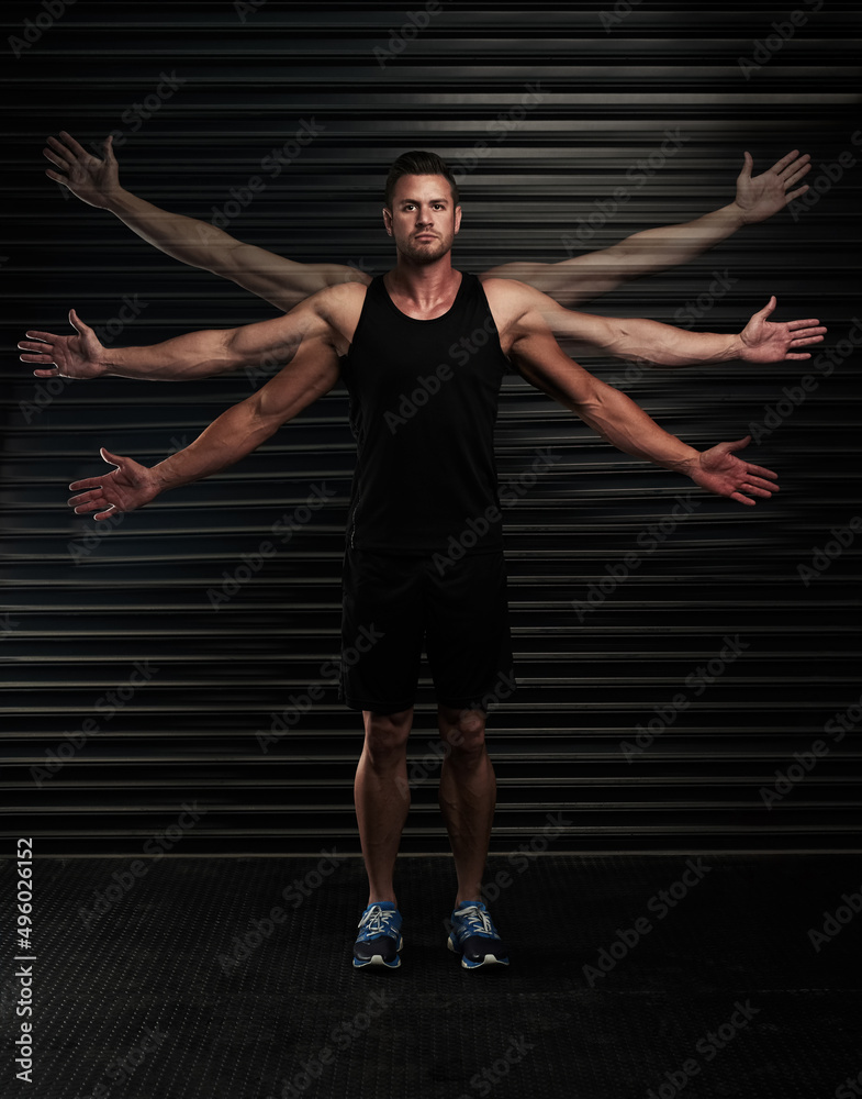 Hes got a full range of motion. Full length portrait of an athletic young man waving his arms in the studio.