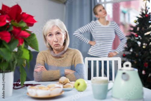 Young daughter angry with elderly mother on Christmas night at home