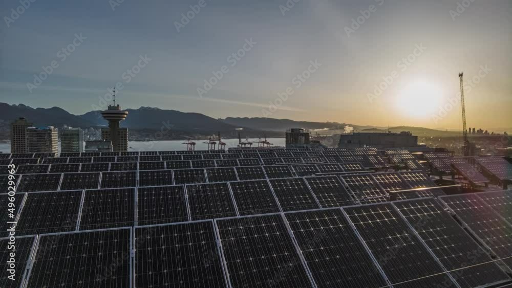 Time lapse solar panel roof station sunset skyline of modern smart city, crane working at sunset in eco sustainable construction site, Vancouver Canada Time lapse solar panel roof station sunset skyline of modern smart city, crane working at sunset in eco sustainable construction site, Vancouver Canada